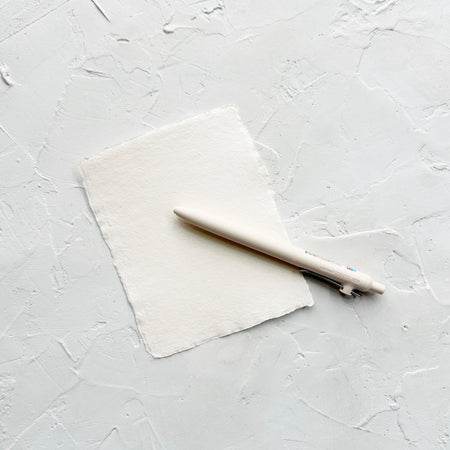 Ivory pen on white textured background