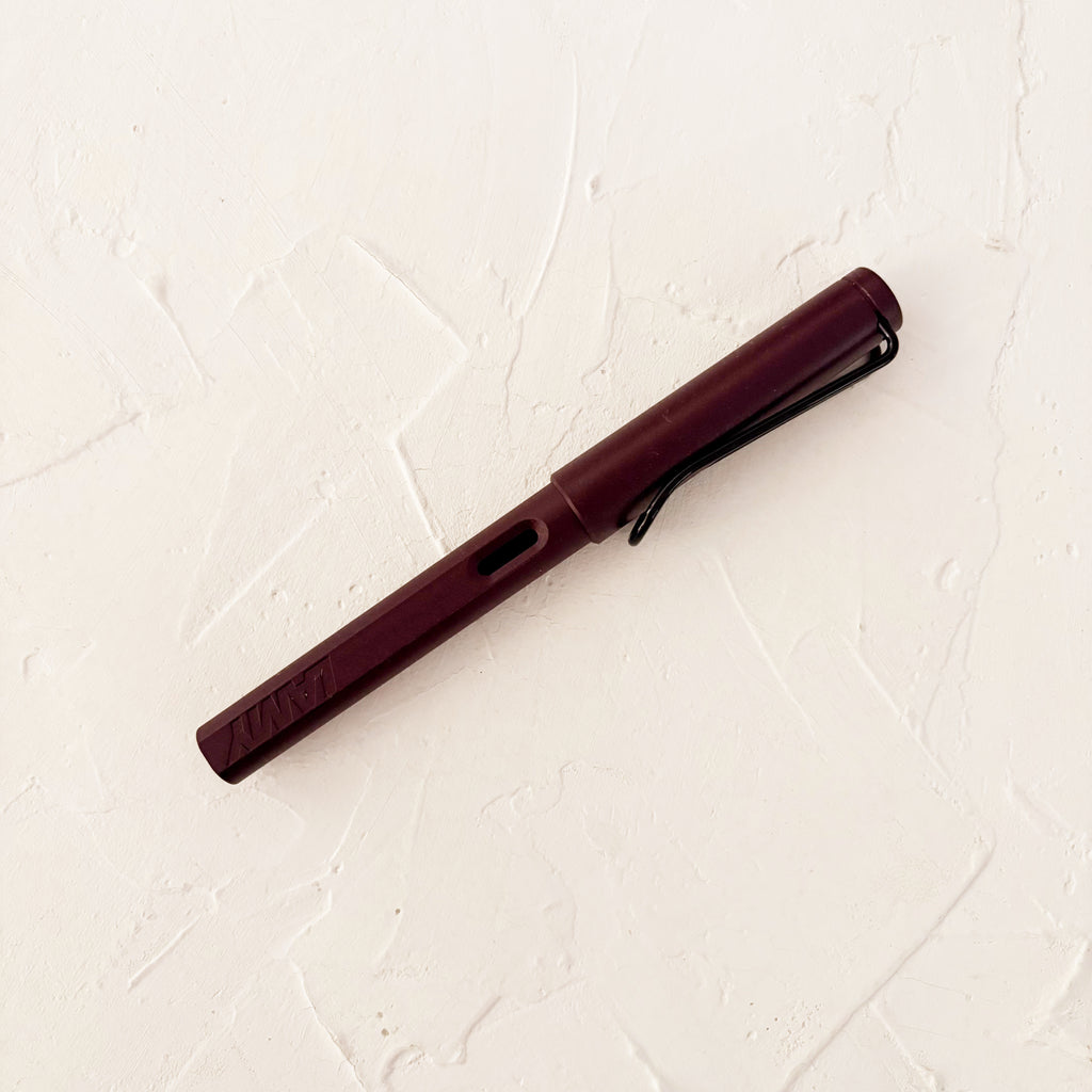 burgundy fountain pen on textured background