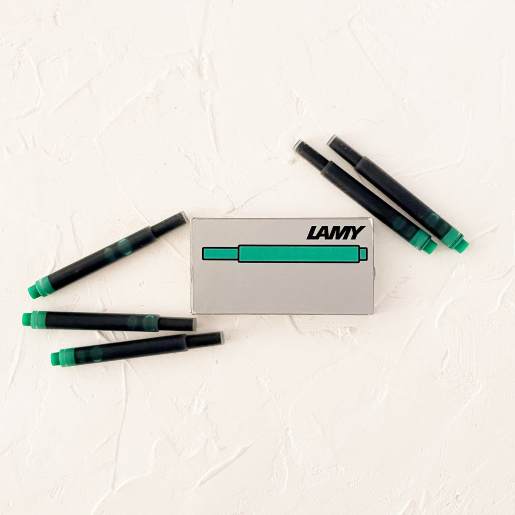 turquoise ink  cartridges on textured white background
