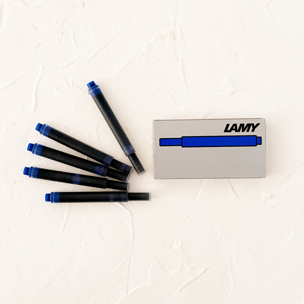 blue ink cartridges on textured white background