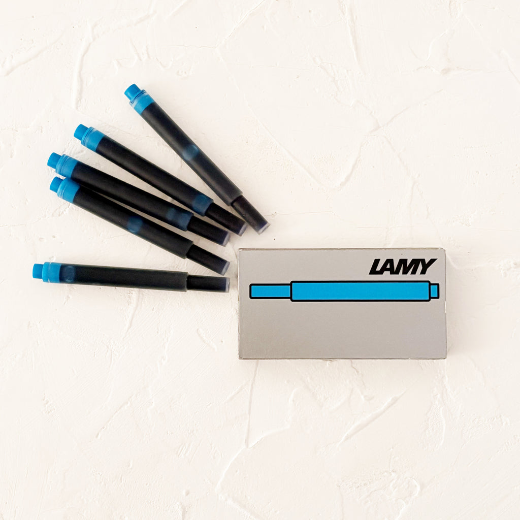 light blue ink cartridges on textured white background