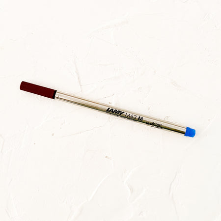 rollerball pen refill on textured background