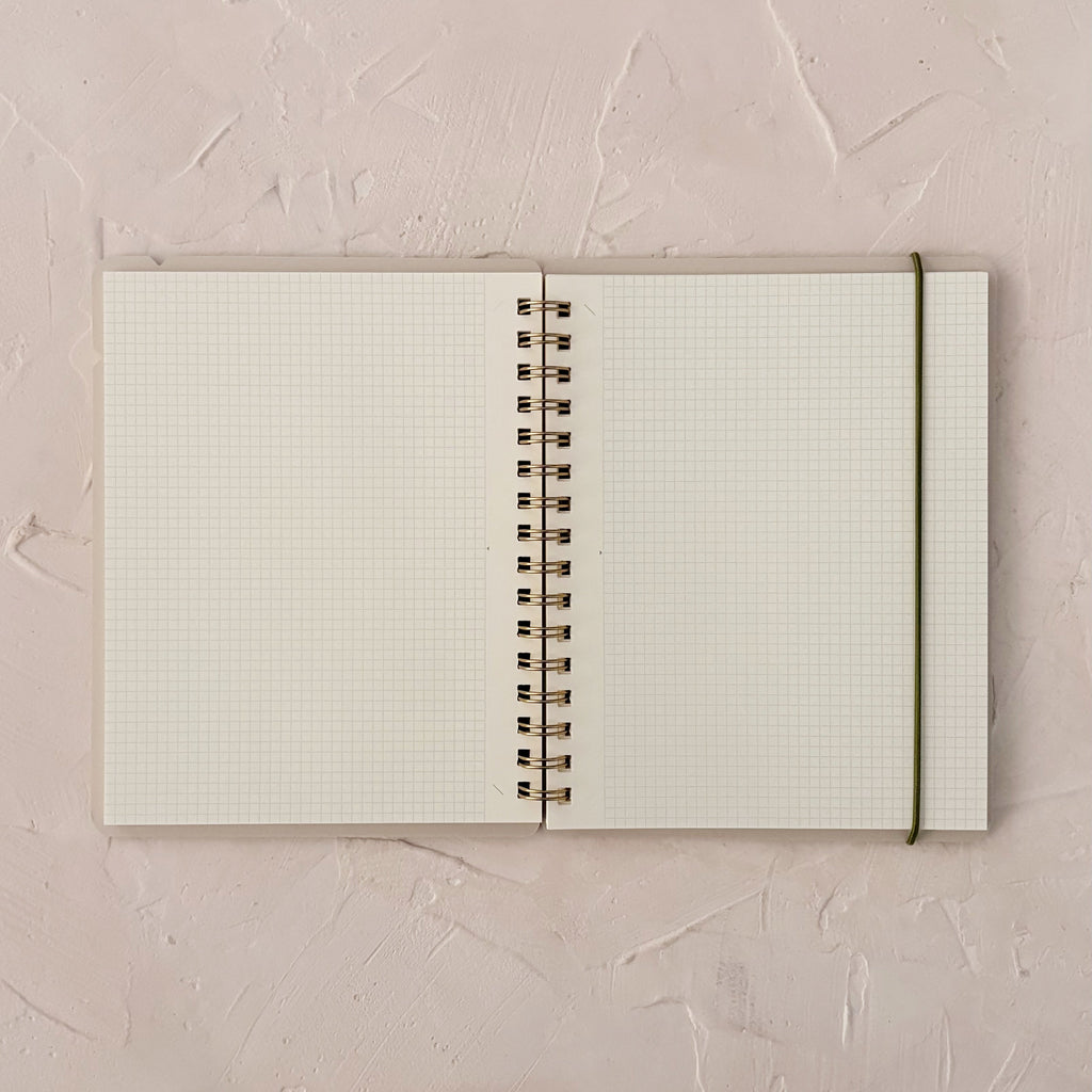 open planner with grid pages on textured background. 