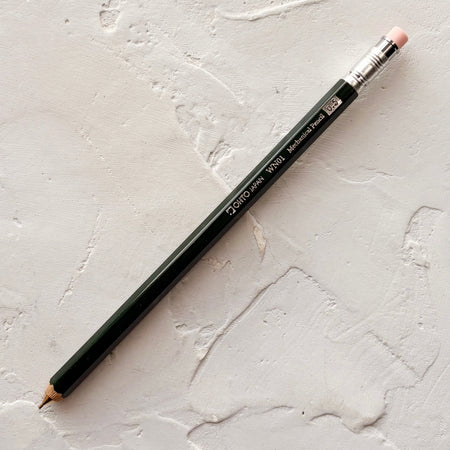 Dark green pencil in textured background