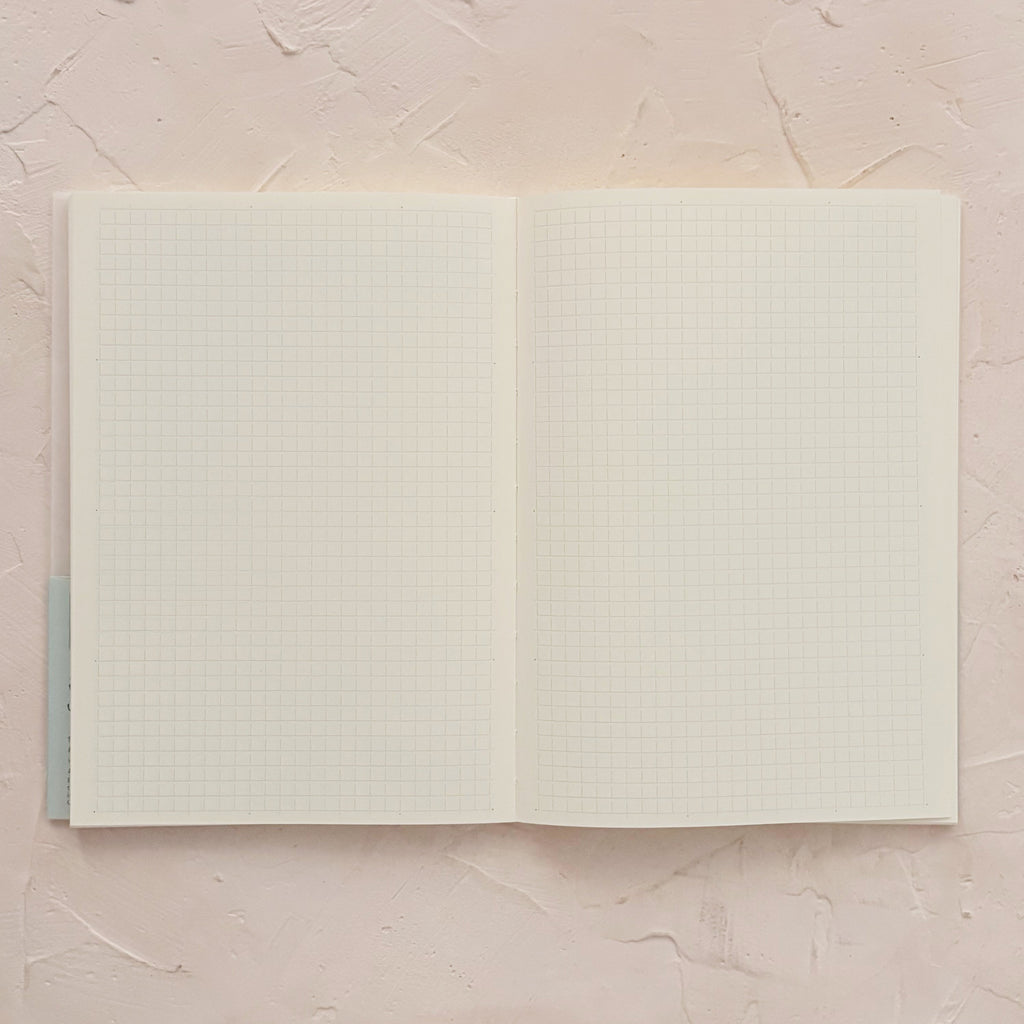 open grid notebook on textured background