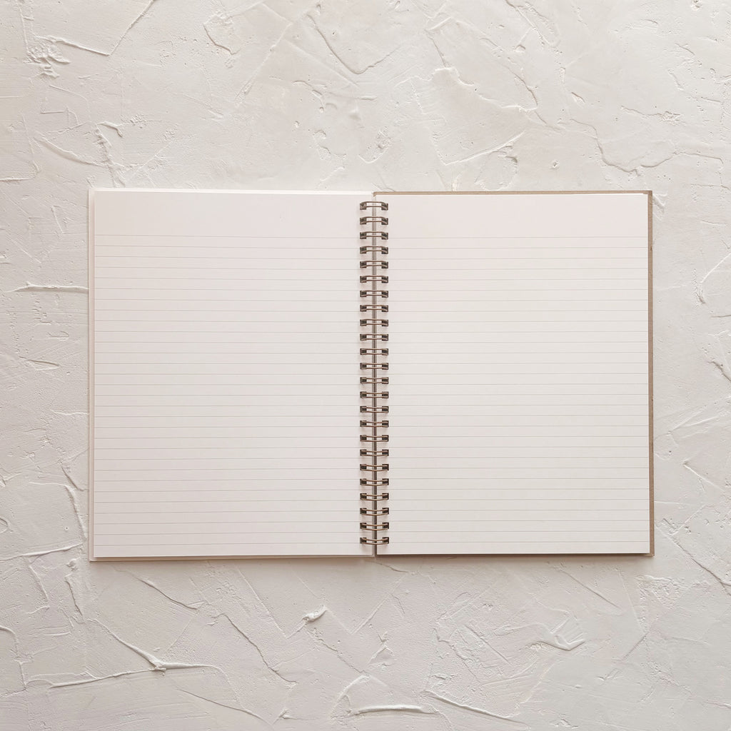 opened lined notebook on textured background