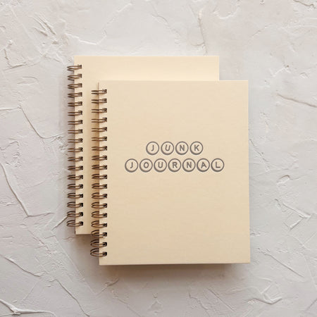 cream notebooks on textured background 