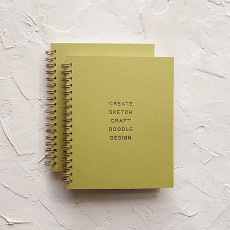 Green notebook with the words 