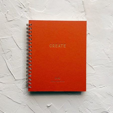 dark orange notebook on textured background