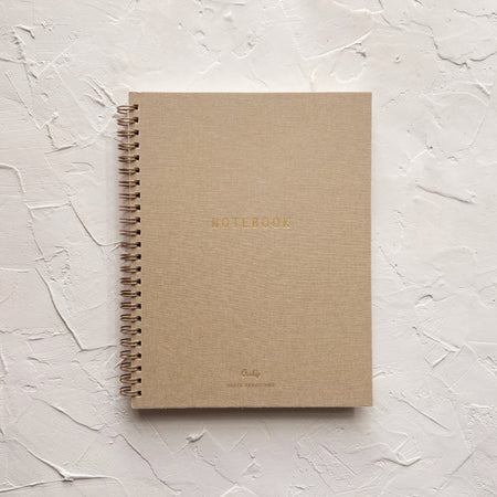 tan notebook on textured background 