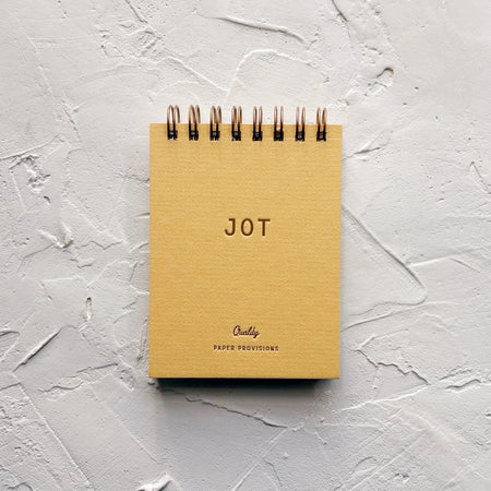 yellow jotter on textured background