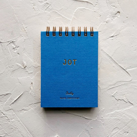 Blue jotter notebook on textured background