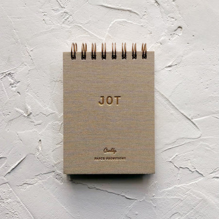 tan jotter notebook on textured background