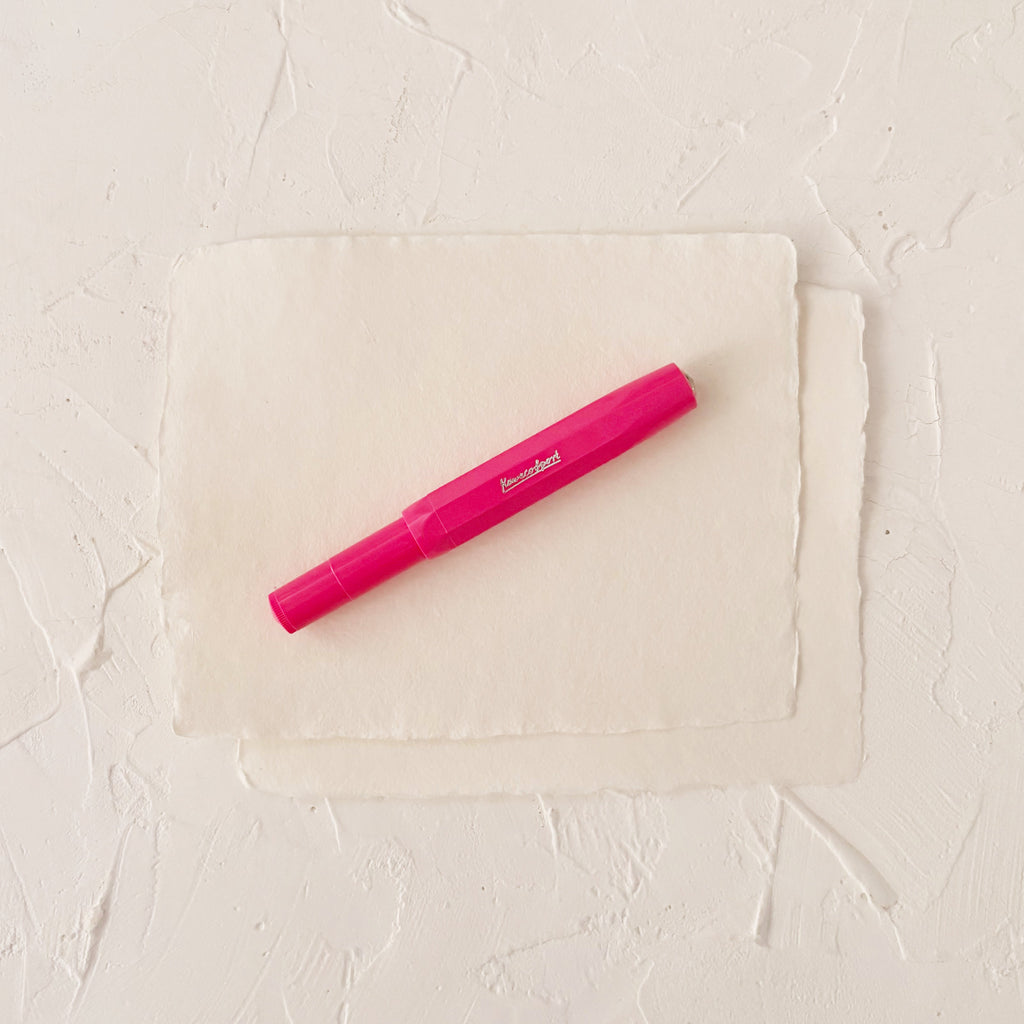 hot pink fountain pen on textured paper