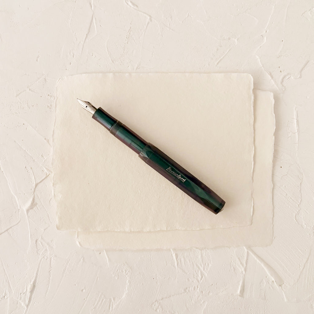 dark blue pearl like fountain pen on textured paper