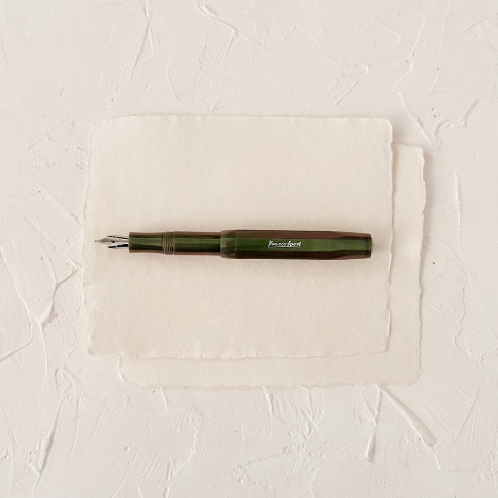 dark green pearl like fountain pen on textured paper