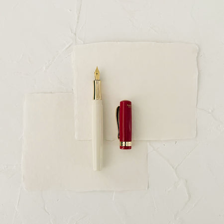red and cream fountain pen on textured paper 
