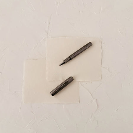 Grey metal rollerball on textured paper