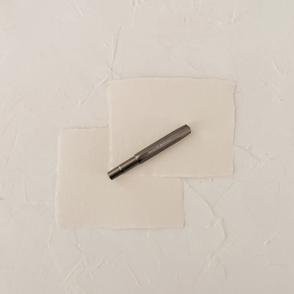 Grey metal rollerball on textured paper