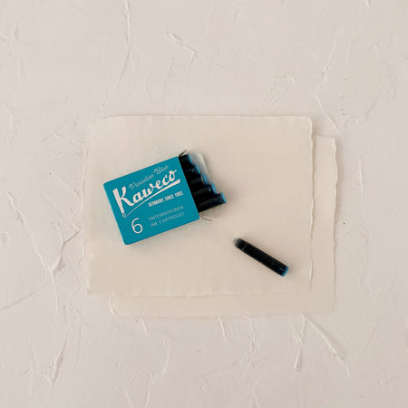blue ink cartridges on textured paper
