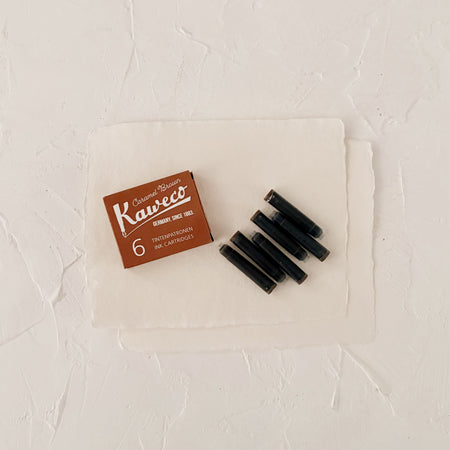 Caramel brown ink cartridges on textured paper