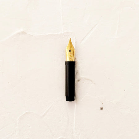 Medium Nib in gold on textured background