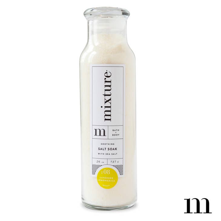 Grapefruit and sweet vanilla scented white bath salt soak packaged in a tall glass bottle.