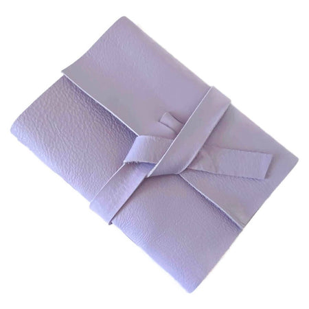 Light Pastel Purple soft leather cover with two leather straps crossed in the middle.