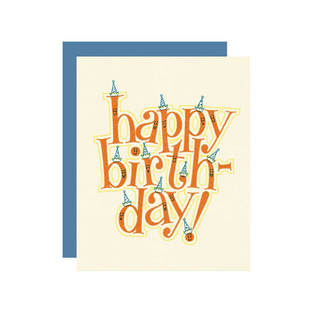 Ivory card with red text letters that have smiley faces and are wearing birthday hats. The letters spell out “Happy Birthday”. A blue envelope is included.