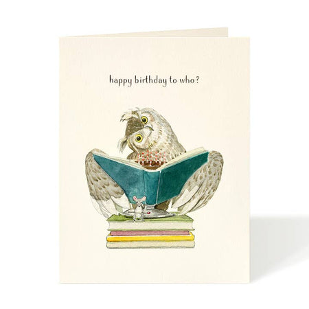 White card with an owl reading a book sitting on a stack of books. Black text saying, “Happy Birthday to Who?” A white envelope is included.