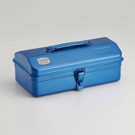 Metalic blue long rectangular steel toolbox with top handle and front latch.
