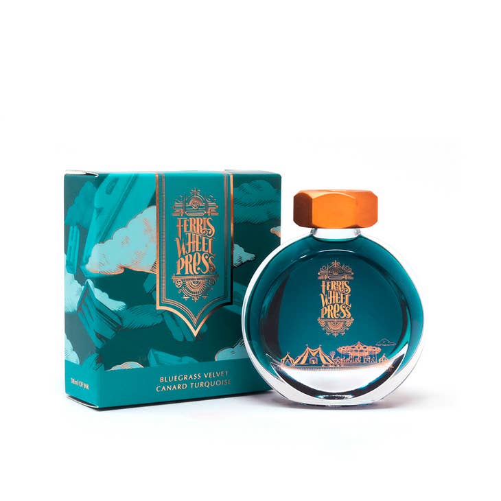 Round glass bottle with gold cover and gold text saying, "Ferris Wheel Press" with images of a carnival on front of bottle. Ink is teal. Packaged in square teal box with images of prairie and clouds.