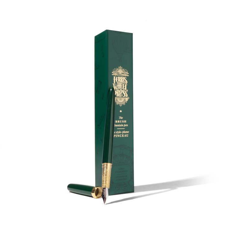Green pen with brass banding and silver nib tip. Green cap with brass banding. Packaged in green rectangular box with gold text saying "Ferris Wheel Press". 