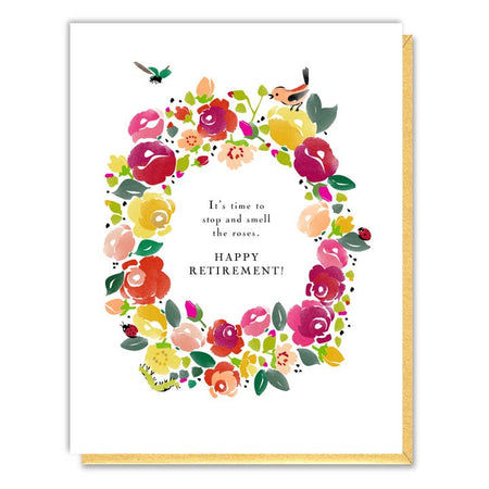 White card with images of a floral wreath with two birds and black text saying, “It’s Time to Stop and Smell the Roses Happy Retirement!”  A yellow envelope is included.