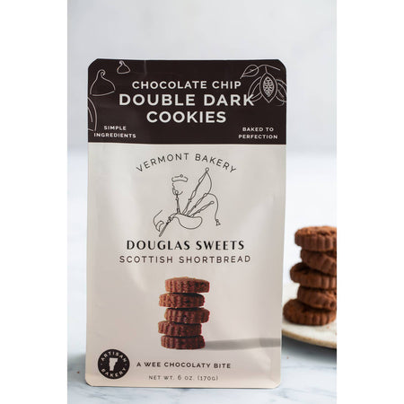 White package with black border on top with white and black text saying, “Douglas Sweets Vermont Bakery Scottish Shortbreads Chocolate Chip Double Dark Cookies”. Image of a stack of shortbread cookies and outline of a man playing bagpipes.