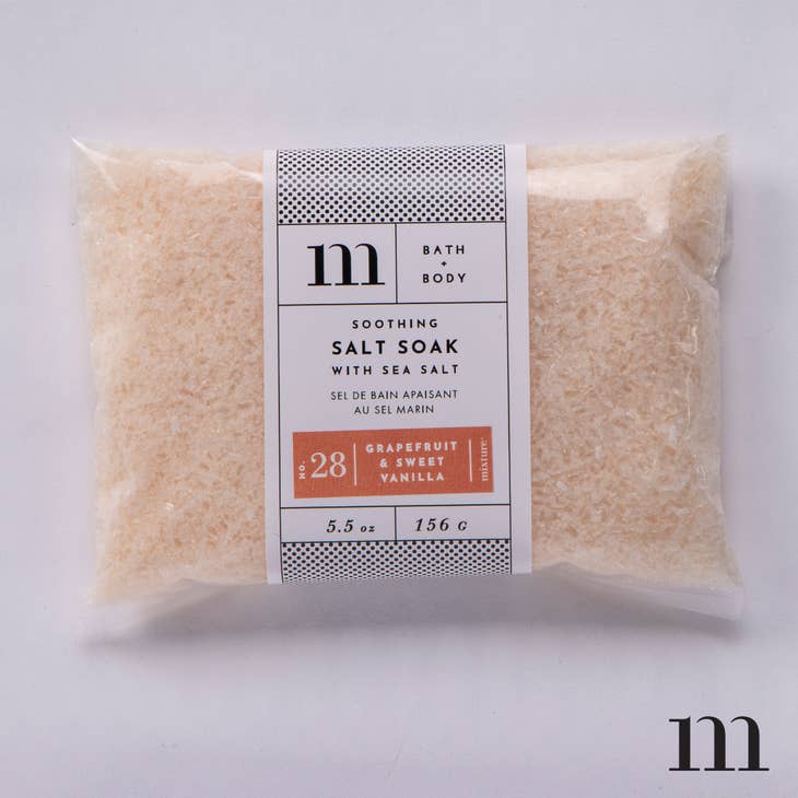 Grapefruit and sweet vanialla scented peach colored bath salt soak packaged in clear plastic.
