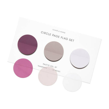 Circle sticky notes in magenta, tan and gray shades presented on a ivory background.