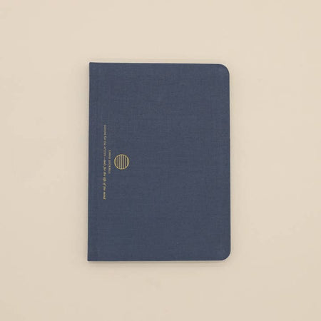 Blue linen cover with gold foil circle logo and text saying, “Linen Journal”.