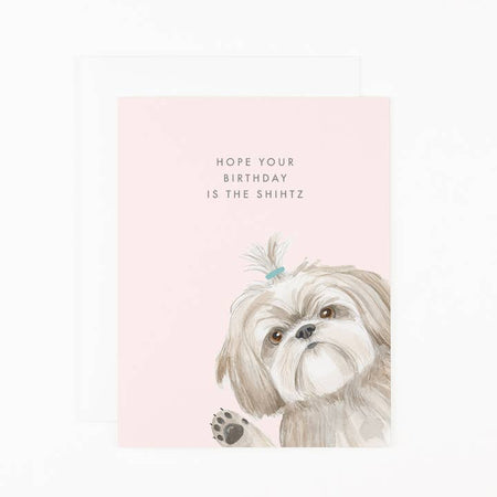 Pink card with image of a gray and white shihtzu dog. Black text saying, “Hope Your Birthday is the Shihtz”. A white envelope is included.
