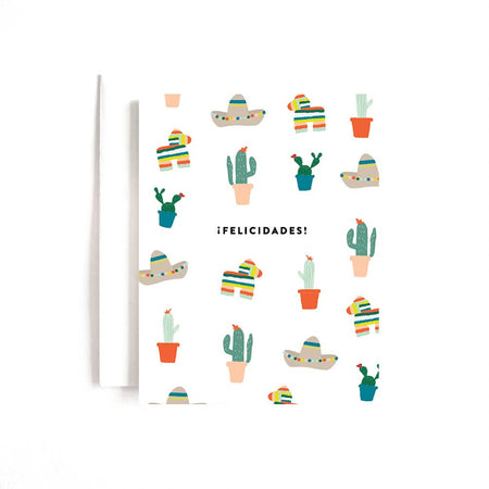 White card with black text saying, “Felicidades!”. Images of sombreros, cactus plants, and piñatas scattered around card. A white envelope is included.