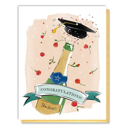 White card with image of a champagne bottle, graduation cap, red flowers and confetti. Black text saying, “Congratulations!” A gold envelope is included.
