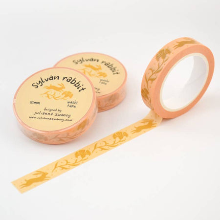 Yellow washi tape with repeating images of yellow flowers and yellow rabbits.