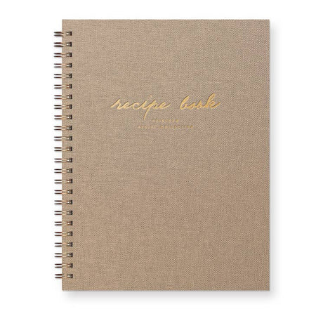 Notebook with sand linen cover with gold foil text saying, 