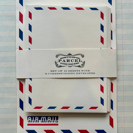 Letter writing set with white paper with a vintage air mail design border or red and blue parallelograms. Matching envelopes included.