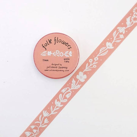 Pink washi tape with repeating images of white floral garland.