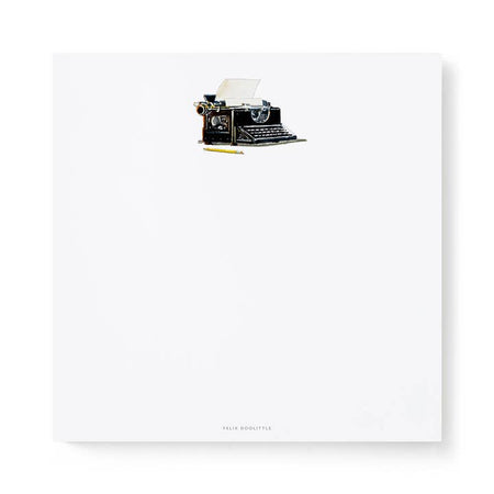 White square notepad with image of a vintage black typewriter in top center of pad.