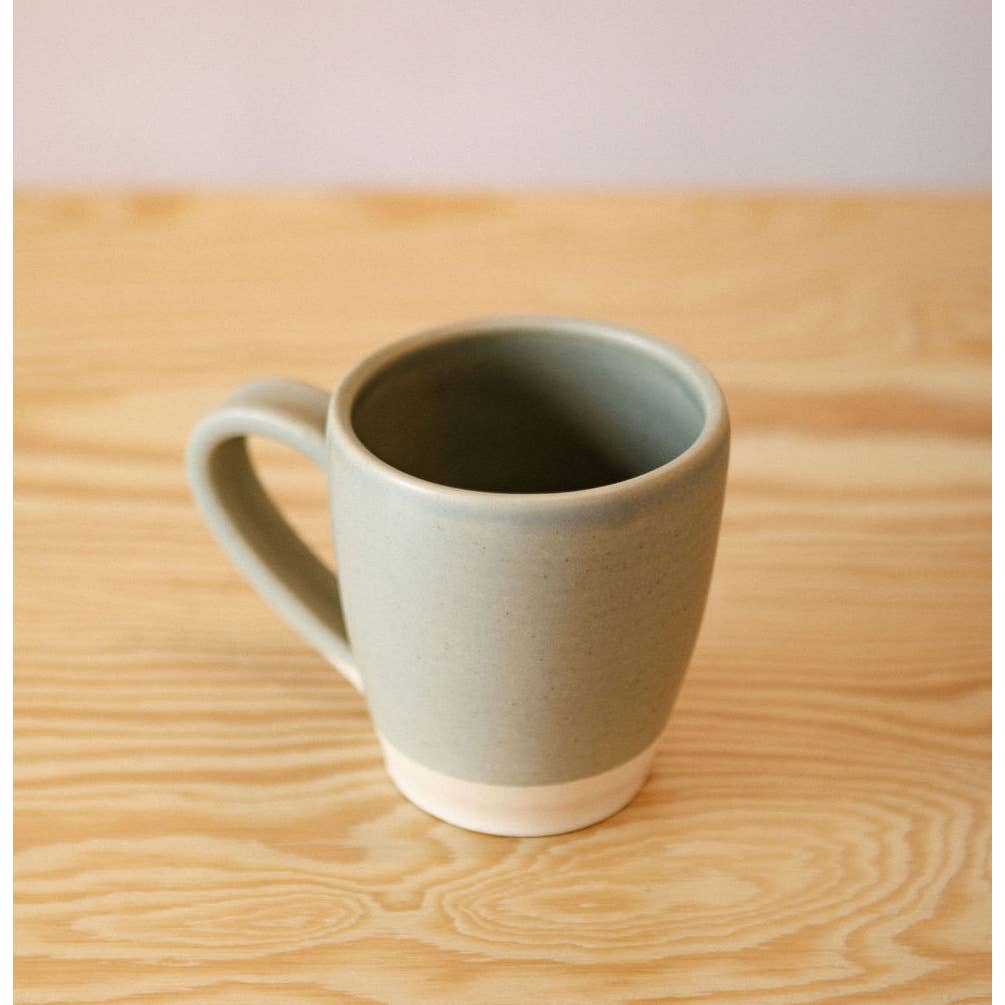 White and gray ceramic mug with curved side handle.