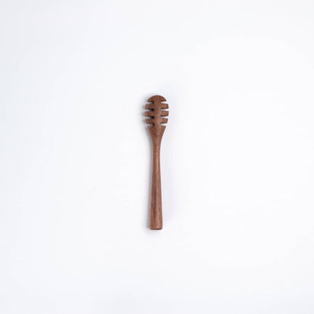 Small wooden honey dipper utensil.