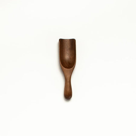 Small wooden shallow scoop utensil.