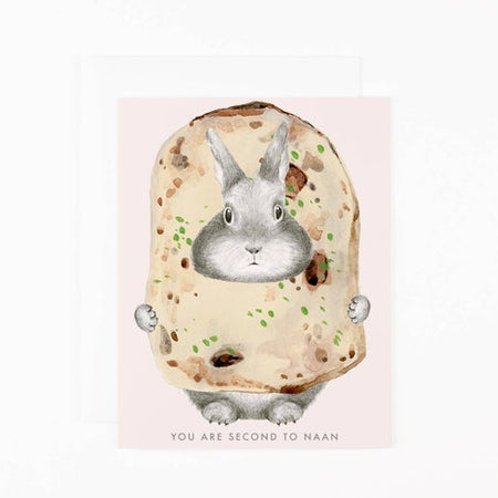 Light pink background with image of a gray rabbit poking its head through a piece of naan bread. Gray text saying, “You Are Second to Naan”. A white envelope is included.